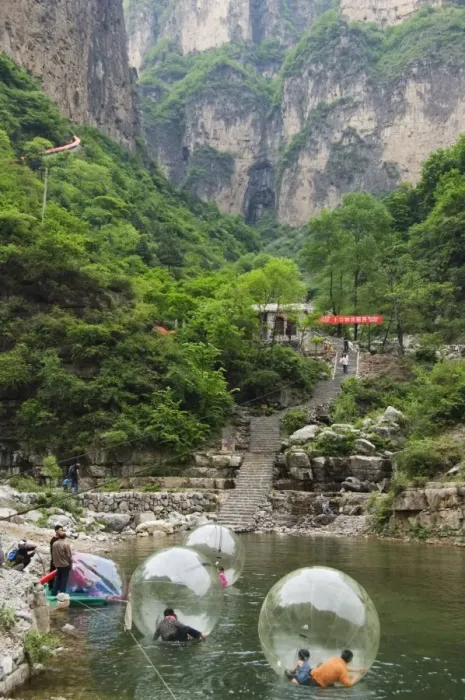 Framed Print : Children playing on river inflatables, Wan Xian mountain recreation area Framed Print : Children playing on river inflatables, Wan Xian mountain recreation area