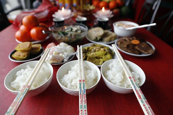 Chinese Lunar New Year, Vietnamese Tet celebration, food and offerings on table, religion at home, Haute Savoie, France, Europe
