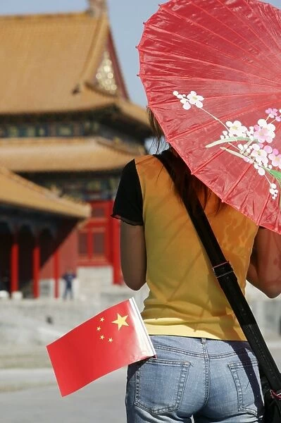 Chinese woman with Chinese flag in the Forbidden City, Beijing (Peking), China, Asia