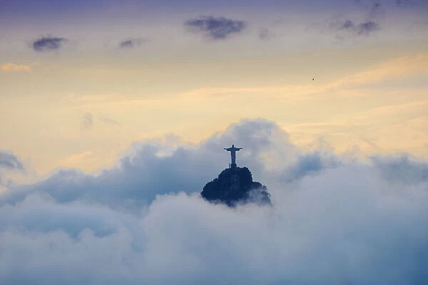 The Christ Statue (Cristo Redentor) on the summit of Corcovado mountain in a sea of clouds, Rio de Janeiro, Brazil, South America
