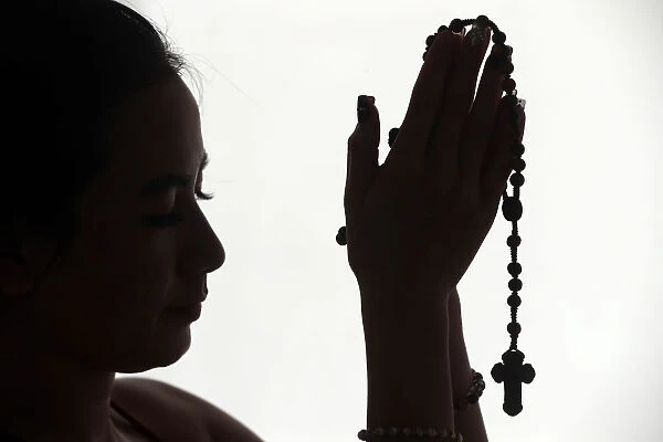 Christian woman praying the Rosary, Vietnam, Indochina, Asia