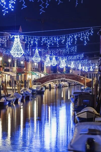 Christmas decorations reflected in a canal, Murano, Venice, UNESCO World Heritage Site, Veneto, Italy, Europe