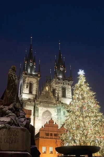 Christmas tree, Gothic Tyn church and statue of Jan Hus at night, Old Town Square