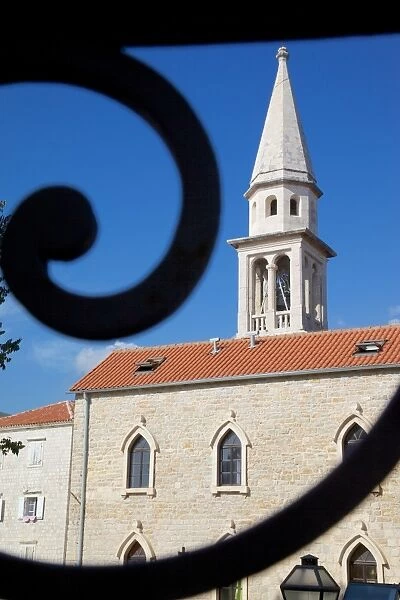 Church belltower viewed through wrought iron railings of the Old Town, Bidva, Montenegro, Europe