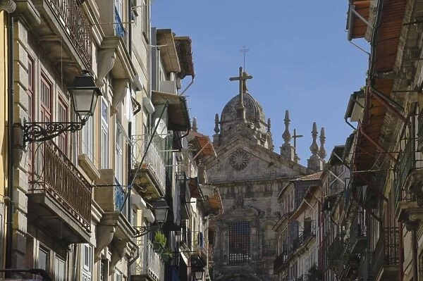 A church dominates a narrow street in the old town, Oporto, Portugal, Europe