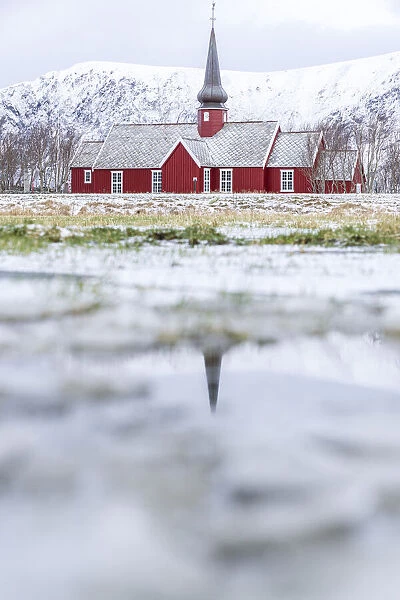Church of Flakstad reflected in a pond in winter, Nordland county, Lofoten Islands, Norway, Scandinavia, Europe