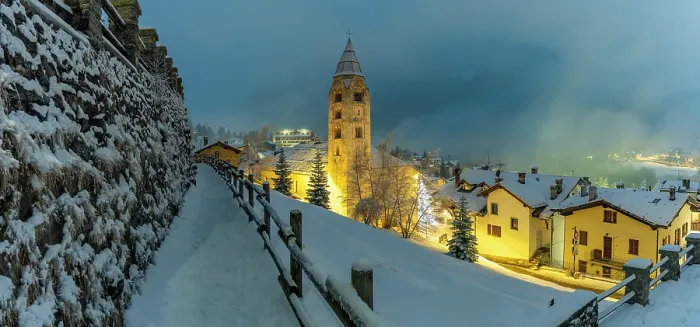 Framed Print : Church of Saint Pantalon and snow covered town centre and mountainous background in winter at dusk, Courmayeur, Aosta Valley, Italian Alps, Italy