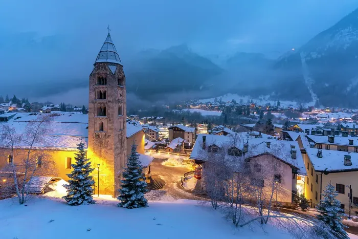 Framed Print : Church of Saint Pantalon, snow covered town centre and mountainous background in winter at dusk, Courmayeur, Aosta Valley, Italian Alps, Italy