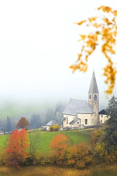 Church of Santa Magdalena in the autumn mist, Funes Valley, Sudtirol (South Tyrol)