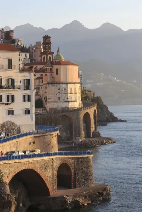 Framed Print : Church of Santa Maria Maddalena and coast road with mountains, warm early morning light Framed Print : Church of Santa Maria Maddalena and coast road with mountains, warm early morning light