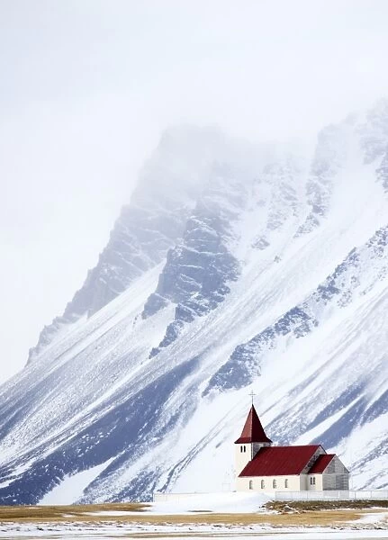 Church against snow covered mountains, winter afternoon, Snaefellsnes Peninsula, Iceland
