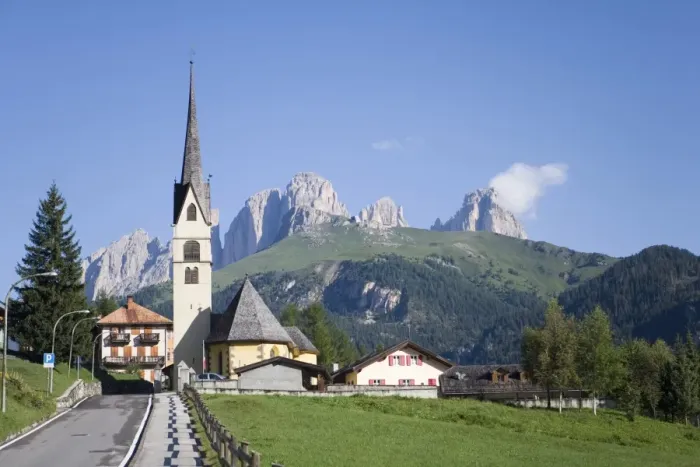 Framed Print : A church in the village of Alba with the rugged peaks of the Sassolungo in the distance Framed Print : A church in the village of Alba with the rugged peaks of the Sassolungo in the distance