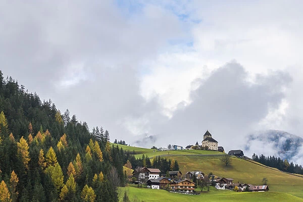 Ciastel de Tor surrounded by woods in autumn, San Martino in Badia, Val Badia, Dolomites
