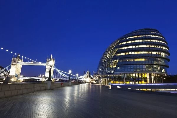City Hall building, the home of the Greater London Authority, with Tower Bridge over the River Thames in the background, Borough of Southwark, London, England, United