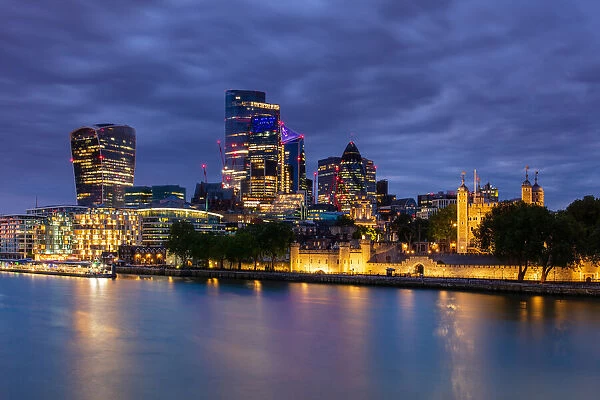 City of London skyscrapers including Walkie Talkie building and Tower of London at dusk