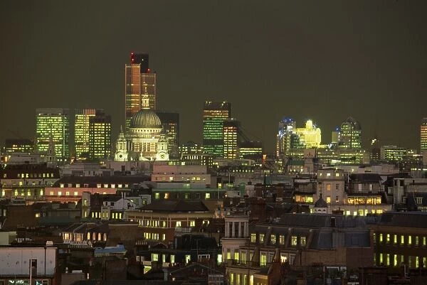 City skyline illuminated at night, including St. Pauls Cathedral, the NatWest Tower