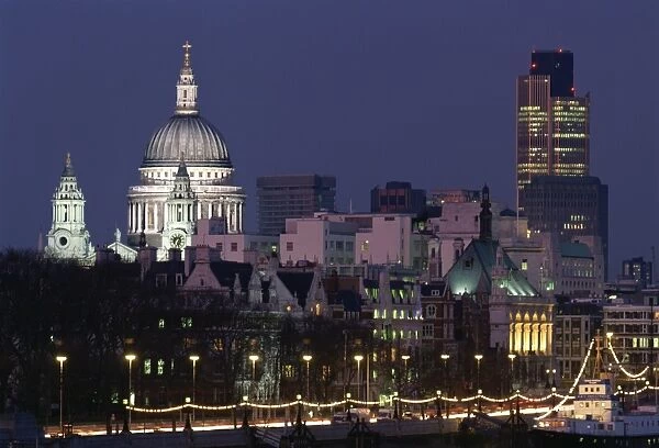 City skyline, including St. Pauls Cathedral and the NatWest Tower, from across the Thames at dusk, London, England, United