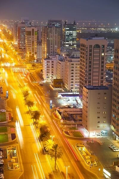 City skyline and Rashid Bin Saeed Al Maktoum Street at dusk, Abu Dhabi, United Arab Emirates, Middle East