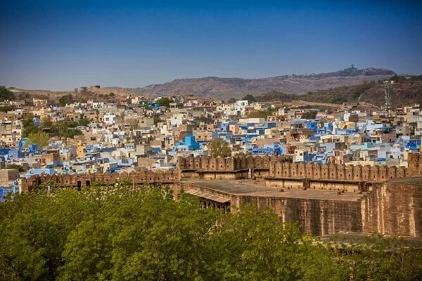 The city wall of Mehrangarh Fort towering over the blue rooftops in Jodhpur, the Blue City