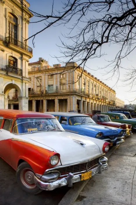 Framed Print : Classic American cars used as taxis for local people, parked outside the main railway station Framed Print : Classic American cars used as taxis for local people, parked outside the main railway station