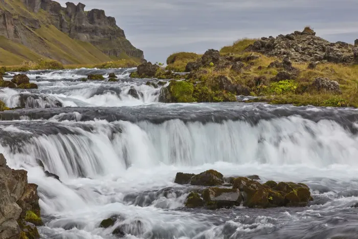 Framed Print : A classic Icelandic landscape, a river flowing along the base of a cliff Framed Print : A classic Icelandic landscape, a river flowing along the base of a cliff