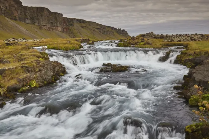 Framed Print : A classic Icelandic landscape, a river flowing along the base of a cliff Framed Print : A classic Icelandic landscape, a river flowing along the base of a cliff