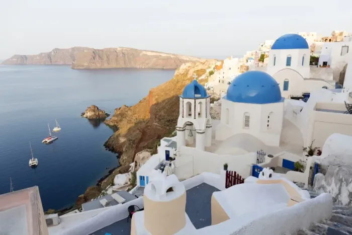 Framed Print : Classic view of the village of Oia with its blue domed churches and colourful houses Framed Print : Classic view of the village of Oia with its blue domed churches and colourful houses