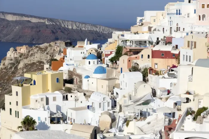 Framed Print : Classic view of the village of Oia with its blue domed churches and colourful houses Framed Print : Classic view of the village of Oia with its blue domed churches and colourful houses