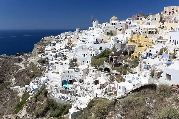 Classic view of the village of Oia with its windmill and whitewashed houses, Oia
