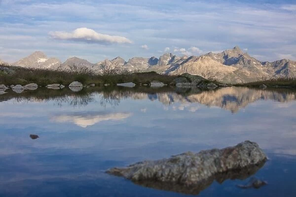 The clear sky is reflected in the blue alpine lake, Muottas Muragl, Samedan, Canton of Graubunden