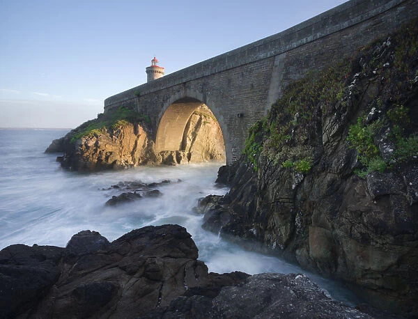 Cliffs and the bridge that lead to the Petit Minou lighthouse with side light at sunset, Finistere, Brittany, France, Europe