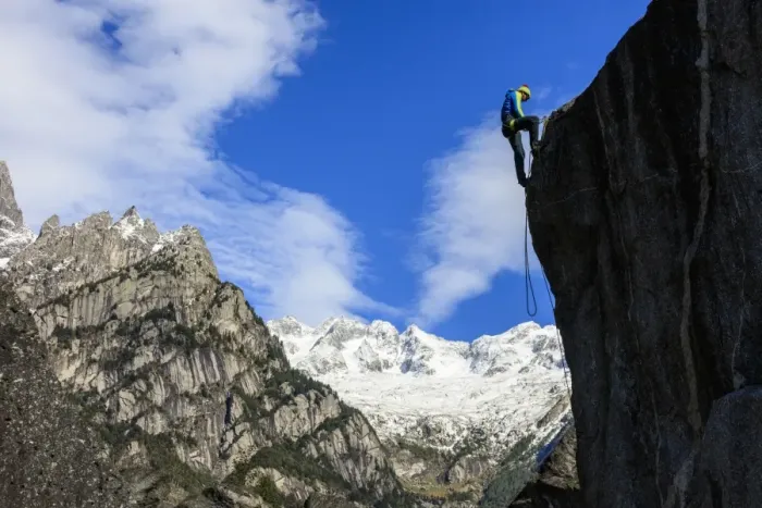 Framed Print : Climber on steep rock face in the background blue sky and snowy peaks of the Alps Framed Print : Climber on steep rock face in the background blue sky and snowy peaks of the Alps