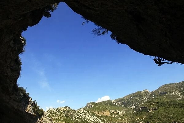 A climber tackles an overhanging climb in the Mascun canyon, Rodellar, Aragon