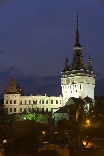 Clock tower (Turnul cu Ceas), illuminated at dusk, formerly the main entrance to the fortified city