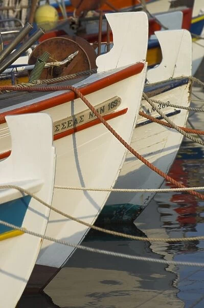 Close up of the front of three fishing boats in the harbour