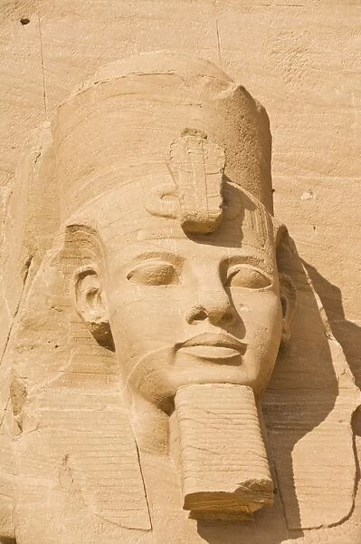 Close up of the head of a giant statue of the great pharaoh Rameses II outside the relocated Temple Rameses II at Abu Simbel, UNESCO World Heritage Site, Egypt, North