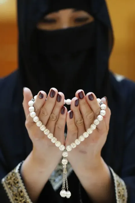 Framed Print : Close up of a Muslim womans hands in abaya while holding rosary and praying Framed Print : Close up of a Muslim womans hands in abaya while holding rosary and praying