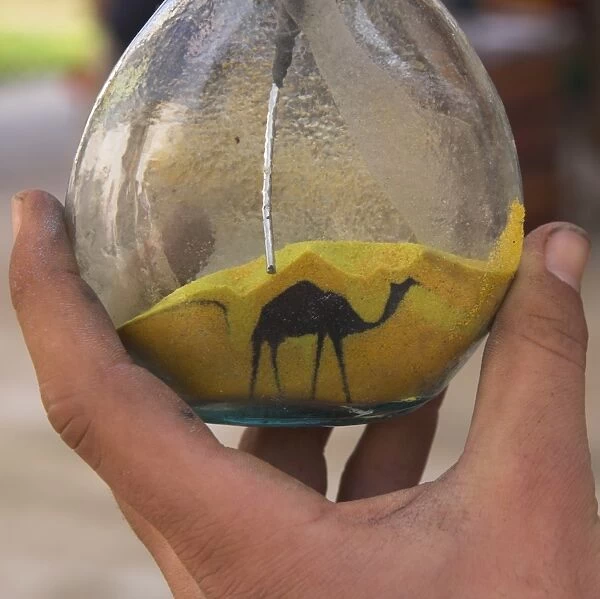 Close up of sand bottle with camel being drawn