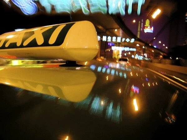 Close up of Taxi sign on car roof with neon road signs, Shanghai, China, Asia