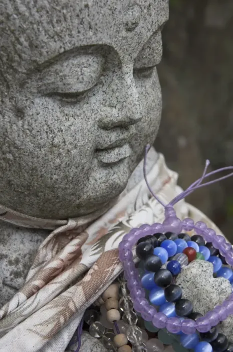 Framed Print : Close up of a traditional stone figure with prayer bracelets Framed Print : Close up of a traditional stone figure with prayer bracelets