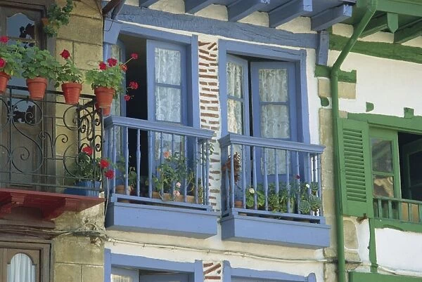 Close-up of balconies and windows painted blue and green