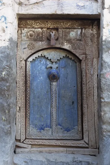 Framed Print : Close-up of a blue door in a carved wood frame in Framed Print : Close-up of a blue door in a carved wood frame in