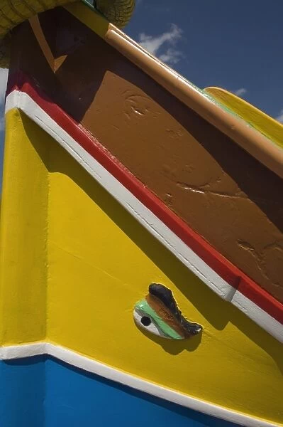 Close-up of a brightly coloured fishing boat (Luzzus) with the eye of Osiris to ward off evil at Marsaxlokk, a fishing village