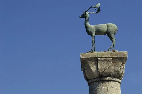 Close-up of Buck statue at the entrance to Mandraki Harbour