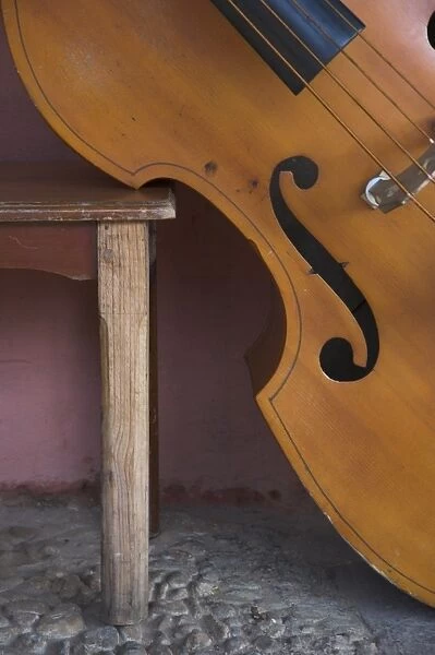 Close-up of a counterbass leaning against a wooden table, Trinidad, Sancti Spiritus province