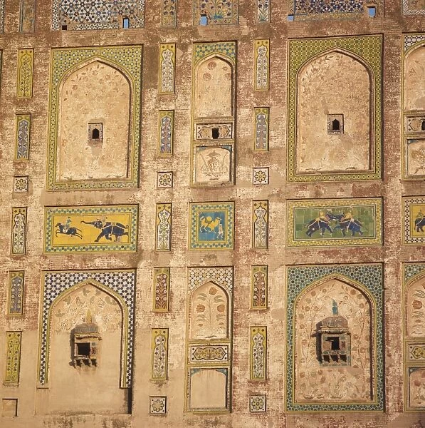 Close-up of decorative tiles on a brick building in Lahore