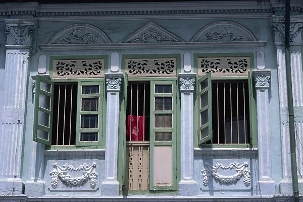 Close-up of door and windows of an old house painted