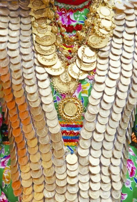 Framed Print : Close-up of a girls dress decorated with old gold coins