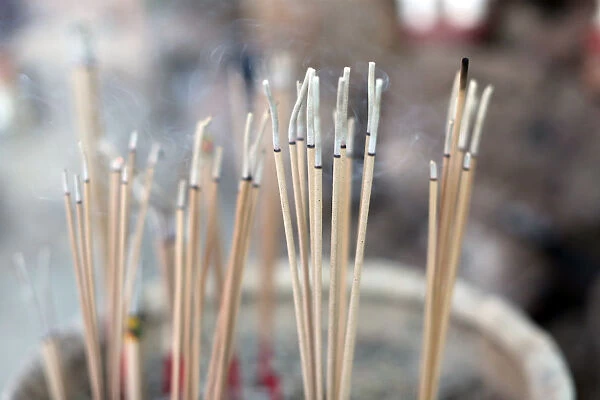 Close-up of incense sticks burning, Wat Si Muang (Simuong) Buddhist temple, Vientiane