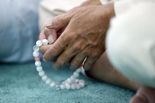 Close-up of man praying in a mosque with Tasbih (prayer beads), Masjid Al Rahim Mosque